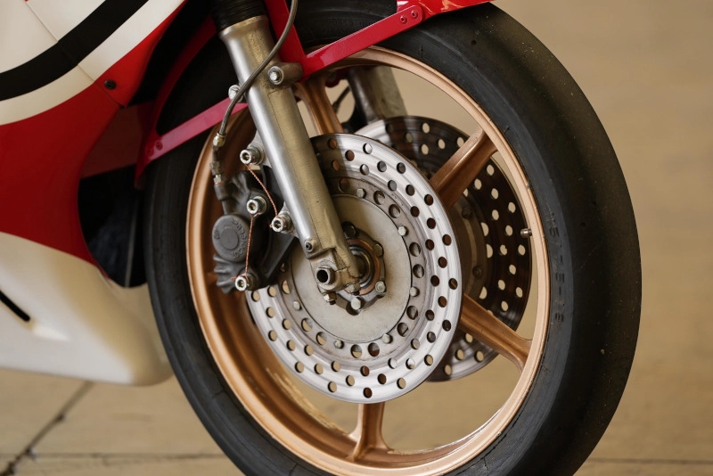 Roue avant de la TZ 750 avec les freins, les jantes dorées et les pneumatiques